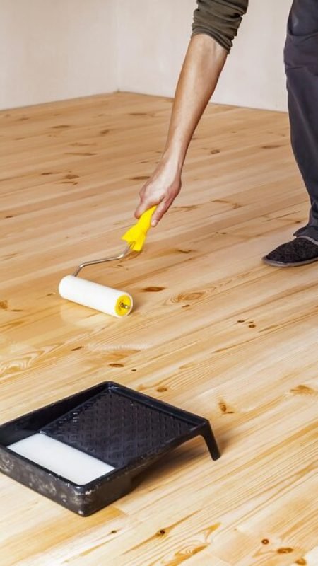 varnishing-wooden-floor-with-roller_203337-1986